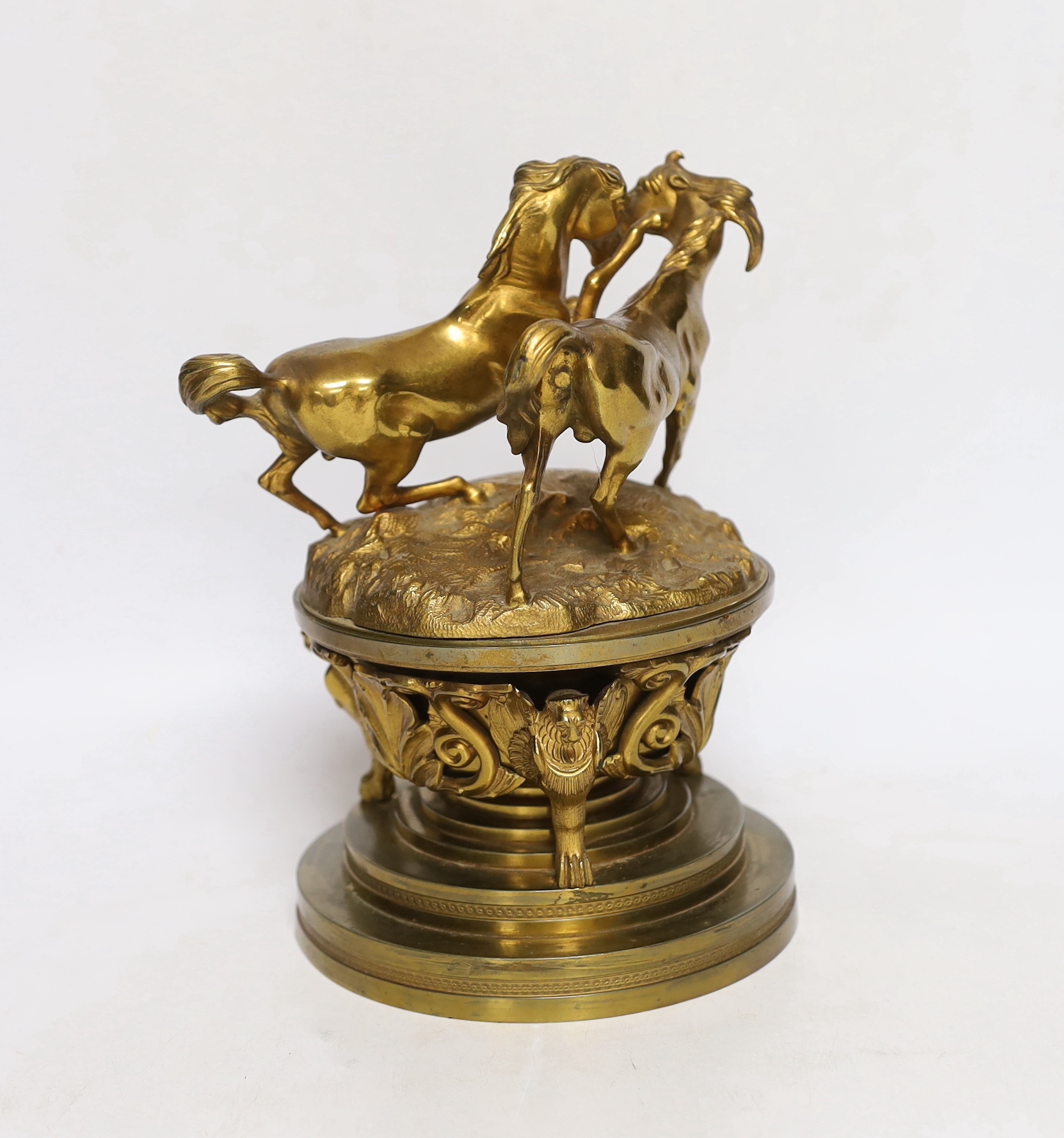 A late 19th century French ormolu dish and cover, surmounted by fighting stallions, 24cm high